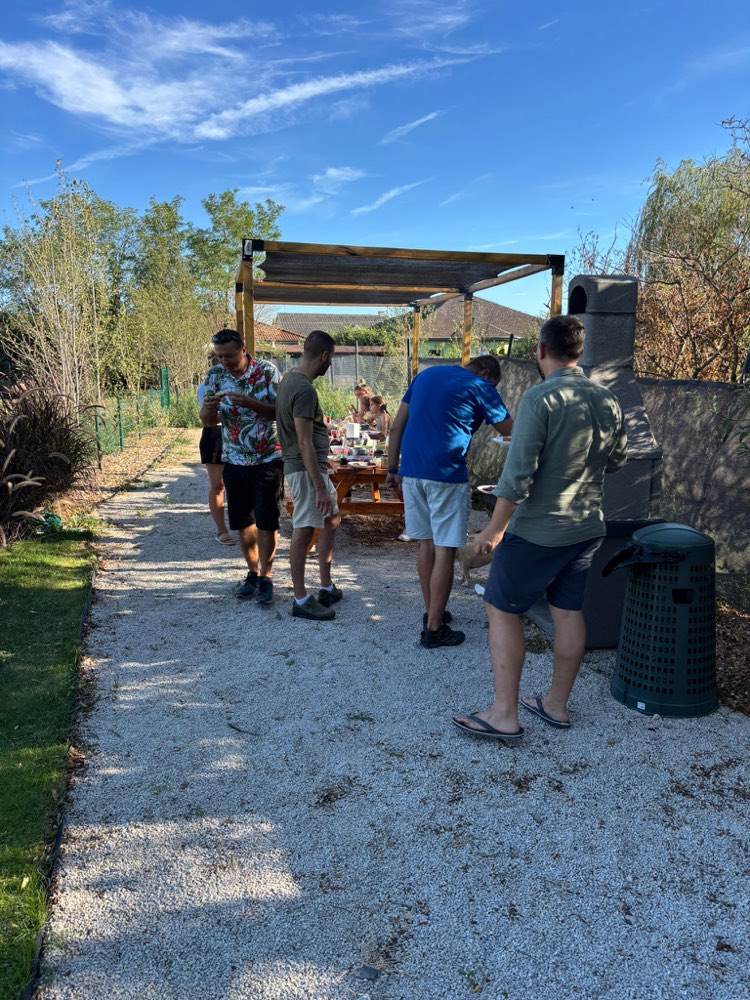 Guests with plates by the grill